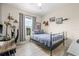 Guest bedroom with ceiling fan and a window view to a peaceful green area at 10203 Courtney Palms Blvd # 301, Tampa, FL 33619
