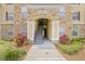 Inviting entrance with stone accents and lush landscaping at 10203 Courtney Palms Blvd # 301, Tampa, FL 33619