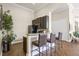 A modern kitchenette featuring stainless steel appliances, counter seating, and hardwood-style flooring at 10203 Courtney Palms Blvd # 301, Tampa, FL 33619
