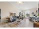 Comfortable living room with a sofa, accent chair, desk, and natural light from a large window at 10203 Courtney Palms Blvd # 301, Tampa, FL 33619