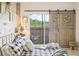 Comfortable main bedroom features a sliding barn door to the patio and a cozy, decorative aesthetic at 10203 Courtney Palms Blvd # 301, Tampa, FL 33619