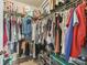 Walk-in closet features ample storage space with shelves and rods for organization at 10203 Courtney Palms Blvd # 301, Tampa, FL 33619