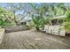 Spacious backyard deck with seating, perfect for outdoor entertaining and enjoying the serene surroundings at 1041 Forest Grove Blvd, Palm Harbor, FL 34683