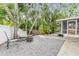 Relaxing backyard with seating area, fire pit, and mature trees, perfect for enjoying the outdoors at 1041 Forest Grove Blvd, Palm Harbor, FL 34683