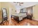 Comfortable bedroom with wood flooring, warm lighting, and a vaulted ceiling at 1041 Forest Grove Blvd, Palm Harbor, FL 34683