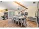 Spacious dining room featuring a vaulted ceiling, wooden beam and ample seating at 1041 Forest Grove Blvd, Palm Harbor, FL 34683