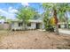 Lovely single-Gathering home with a manicured lawn, front garden, and a vibrant turquoise door at 1041 Forest Grove Blvd, Palm Harbor, FL 34683