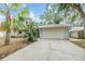 Charming single-story home featuring a two-car garage, mature landscaping, and a concrete driveway at 1041 Forest Grove Blvd, Palm Harbor, FL 34683