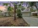 Charming home featuring mature landscaping, a two-car garage and a welcoming driveway at 1041 Forest Grove Blvd, Palm Harbor, FL 34683