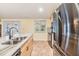 Bright kitchen featuring granite countertops, stainless steel appliances, and a view of the patio at 1041 Forest Grove Blvd, Palm Harbor, FL 34683