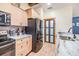 Modern kitchen featuring stainless steel appliances, light wood cabinets, and granite countertops at 1041 Forest Grove Blvd, Palm Harbor, FL 34683