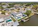 Aerial view of waterfront home with a pool, boat dock, fenced yard, and canal access at 10710 Donbrese Ave, Tampa, FL 33615