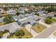 Aerial view showcases a home with a long driveway and landscaping near a waterway at 10710 Donbrese Ave, Tampa, FL 33615