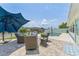 Inviting backyard patio with outdoor seating, a swimming pool, and waterfront views at 10710 Donbrese Ave, Tampa, FL 33615