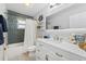Beautiful bathroom featuring blue tiled walls, a white vanity, and stylish nautical-themed decor at 10710 Donbrese Ave, Tampa, FL 33615
