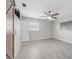 Comfortable bedroom with a ceiling fan and ample natural light from two windows at 10710 Donbrese Ave, Tampa, FL 33615