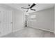 Bright bedroom with neutral colors, closet, and modern ceiling fan fixture at 10710 Donbrese Ave, Tampa, FL 33615