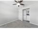 Neutral bedroom with tile floors, a ceiling fan, and a closet with built-in shelving at 10710 Donbrese Ave, Tampa, FL 33615