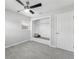 Bright bedroom with neutral colors, closet, and modern ceiling fan fixture at 10710 Donbrese Ave, Tampa, FL 33615