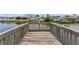 Long wooden dock showcasing scenic waterfront views of neighboring homes at 10710 Donbrese Ave, Tampa, FL 33615