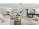 Bright and airy living room with modern decor and seamless flow into the dining area at 10710 Donbrese Ave, Tampa, FL 33615