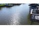 Waterfront view of docks with boats and boat covers on a sunny day with calm water at 10710 Donbrese Ave, Tampa, FL 33615