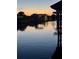 Picturesque waterfront view featuring calm waters, boat docks, and a vibrant sunset reflecting on the water's surface at 10710 Donbrese Ave, Tampa, FL 33615