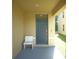 Inviting front entrance featuring a modern blue door, light colored bench and covered porch at 10928 Carlton Fields Dr, Riverview, FL 33579