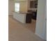 A kitchen island features dark cabinets, granite countertop, and stainless steel sink at 10928 Carlton Fields Dr, Riverview, FL 33579