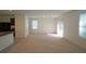 Spacious living room with carpeted floors, ample natural light, and an open layout at 10928 Carlton Fields Dr, Riverview, FL 33579