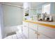 Bright bathroom with clean white countertop, shower and sleek white tiling at 1111 Briarwood Rd, Brandon, FL 33511