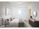Well-lit bedroom featuring neutral paint, wood floors, and a modern dresser at 1111 Briarwood Rd, Brandon, FL 33511