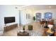 Open concept living room leading into dining area and kitchen with sleek hardwood floors at 1111 Briarwood Rd, Brandon, FL 33511