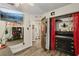 Spacious bedroom boasts wood-look floors, closet, and mounted TV, creating a comfortable and stylish retreat at 11849 Cedarfield Dr, Riverview, FL 33579