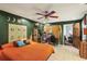 Bedroom featuring tile floors, unique wall decor, and an inviting bed at 11849 Cedarfield Dr, Riverview, FL 33579