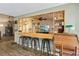 Dining area featuring a breakfast bar with seating for four, next to a well-lit living room at 11849 Cedarfield Dr, Riverview, FL 33579