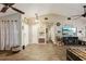 Open-concept living space featuring wood-look tile flooring, ceiling fan, and comfortable seating at 11849 Cedarfield Dr, Riverview, FL 33579