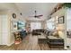 Spacious living room with wood-look tile flooring, ceiling fan, and comfortable seating at 11849 Cedarfield Dr, Riverview, FL 33579