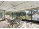 Enclosed patio features outdoor seating with views of the landscaped yard, offering a peaceful and relaxing retreat at 11849 Cedarfield Dr, Riverview, FL 33579