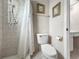 Tiled shower and toilet with coordinated fixtures at 12125 71St Way, Largo, FL 33773