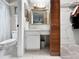 Well-lit bathroom with a vanity, mirror, and ample storage near a walk-in closet at 12125 71St Way, Largo, FL 33773