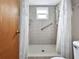Bright bathroom with tiled shower stall, grab bar, and convenient accessibility at 12125 71St Way, Largo, FL 33773