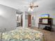 Comfortable bedroom features ceiling fan with an attached bathroom and walk in closet at 12125 71St Way, Largo, FL 33773
