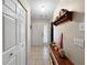 Inviting foyer with tile flooring, coat closet, and convenient shelf at 12125 71St Way, Largo, FL 33773