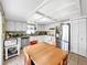 Bright kitchen features white cabinets, stainless steel appliances, and a cozy eat-in area at 12125 71St Way, Largo, FL 33773