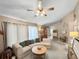 Spacious living room featuring a ceiling fan, neutral carpet, and access to the bathroom at 12125 71St Way, Largo, FL 33773