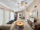 Cozy living room with ceiling fan, neutral carpet, and plenty of natural light at 12125 71St Way, Largo, FL 33773
