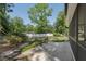 Backyard exterior features a patio, lush greenery, and a privacy fence, creating a private outdoor space at 1221 Candlelight Blvd, Brooksville, FL 34601