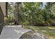 Secluded backyard features a patio, mature trees, a green lawn, and a combination of fencing at 1221 Candlelight Blvd, Brooksville, FL 34601