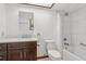 Well-lit bathroom with modern fixtures, a combination tub and shower, and ample storage in the dark wood vanity at 1221 Candlelight Blvd, Brooksville, FL 34601